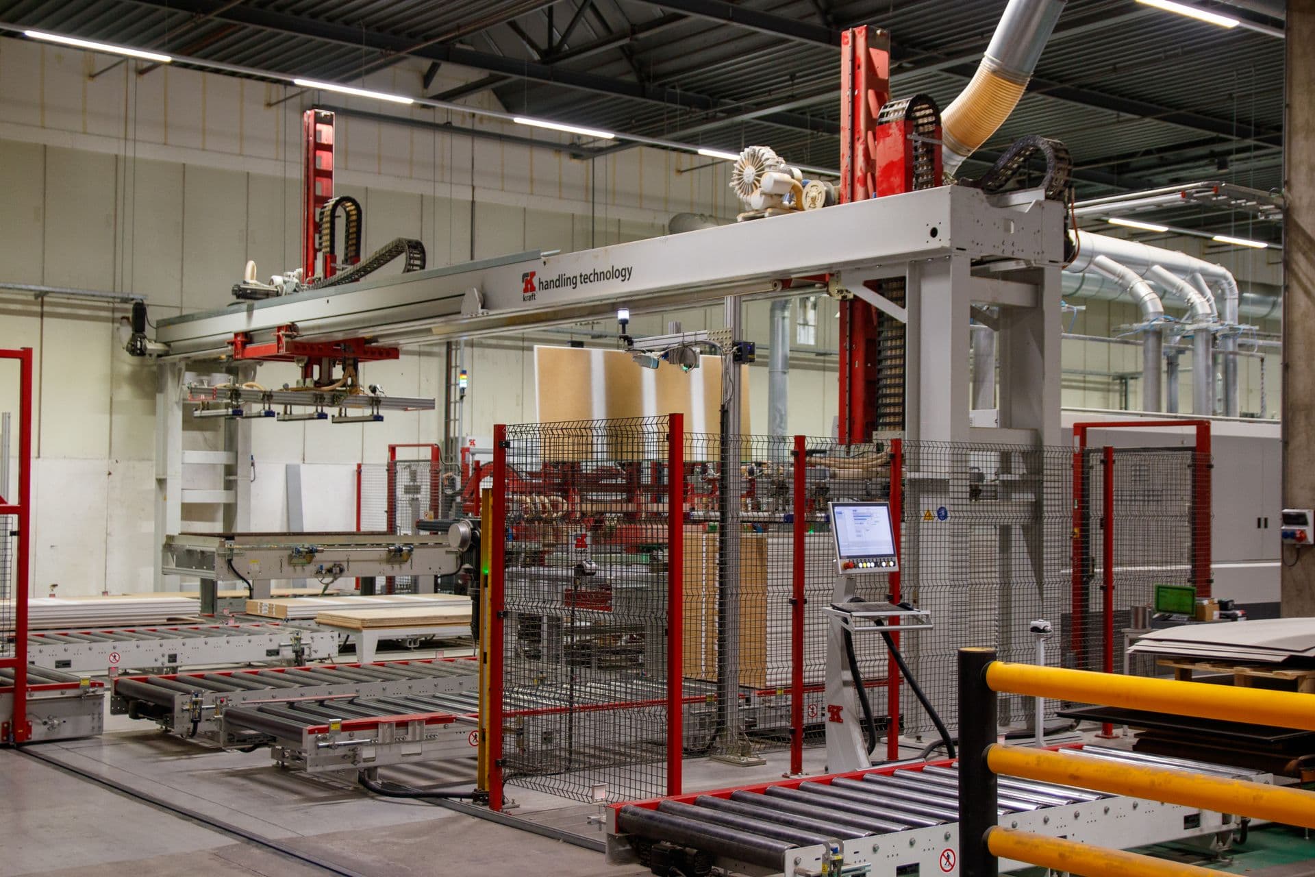 Industrial automated gantry system on a clean factory floor.